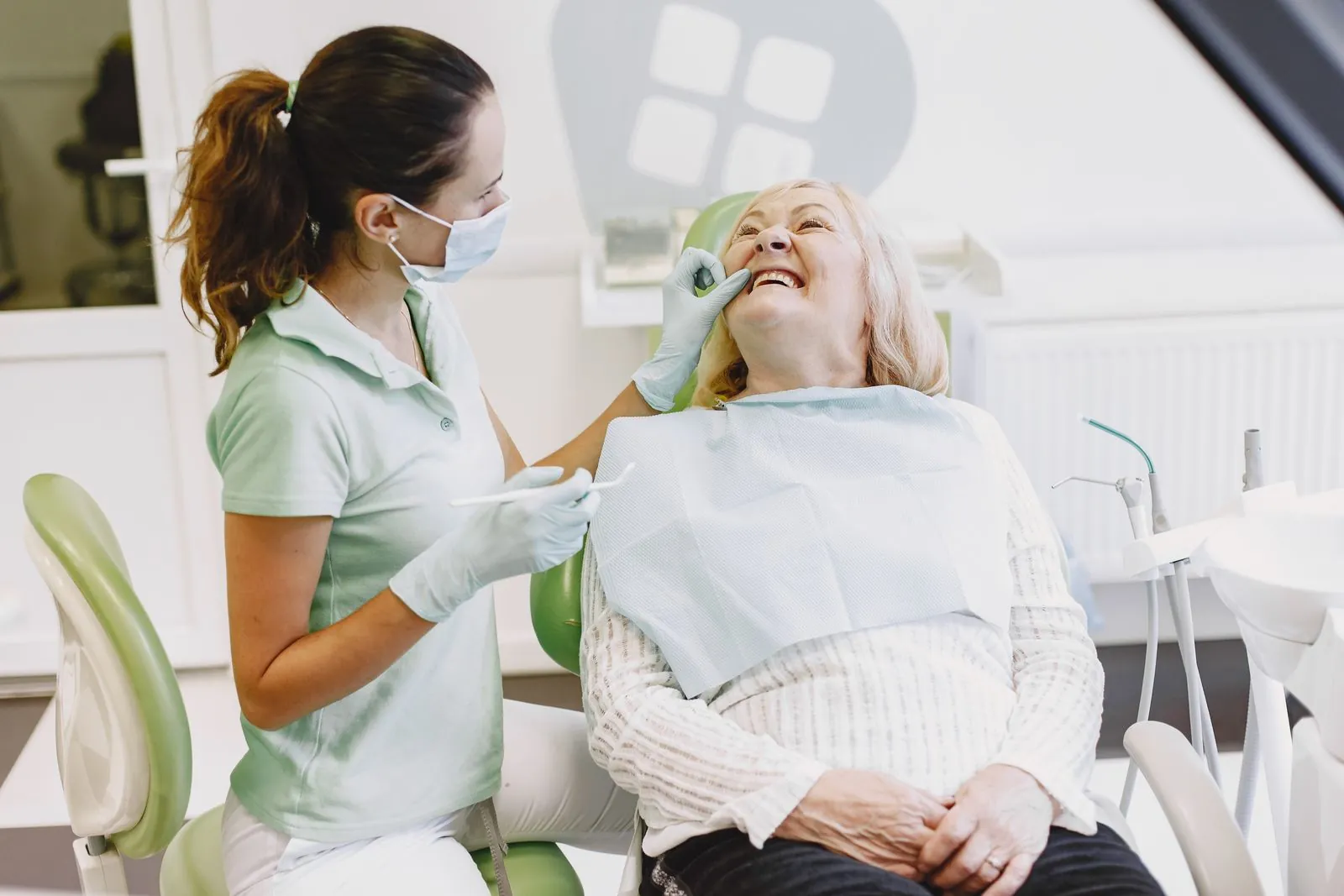 A hygienist with a smiling patient